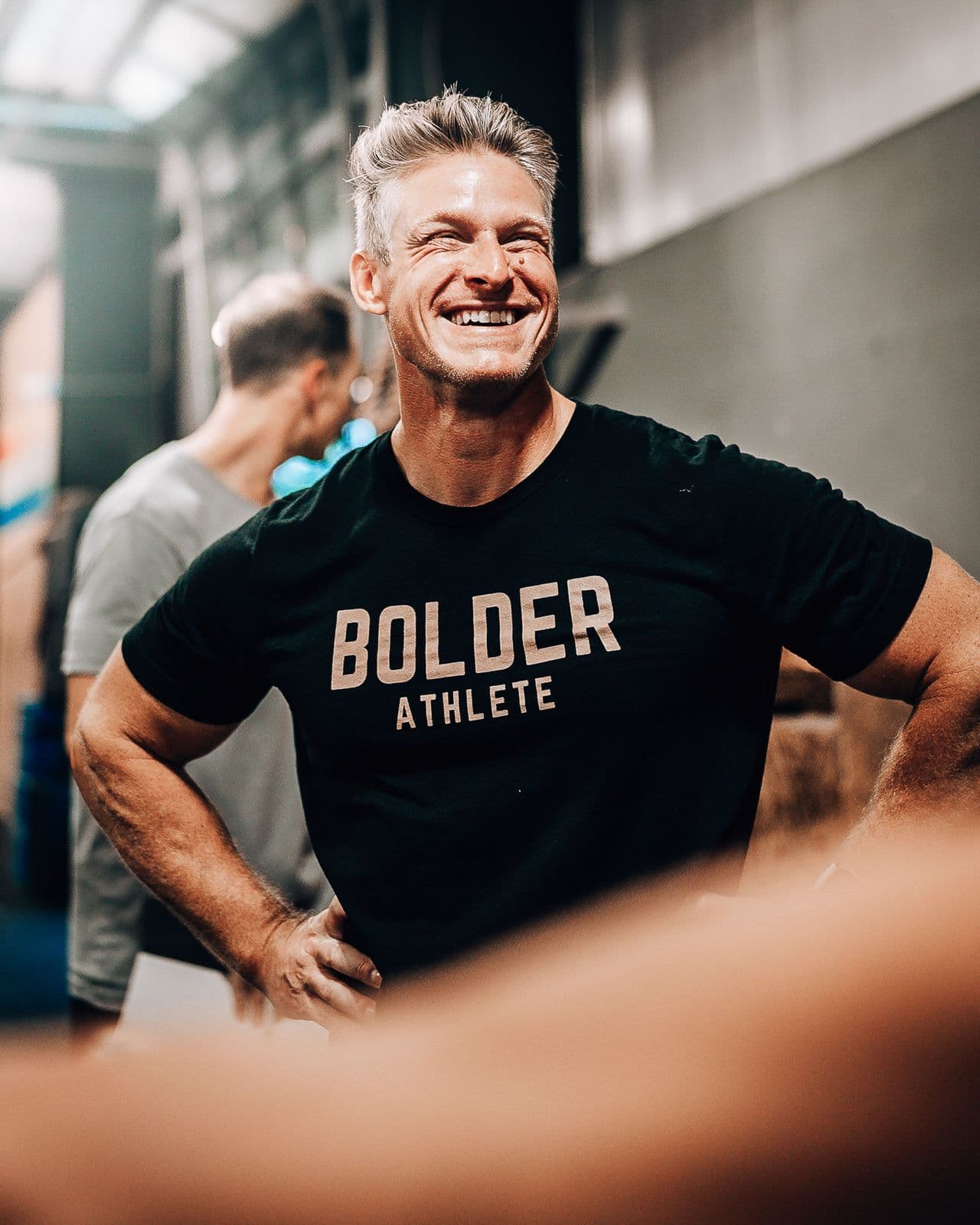 Athlete in a Bolder Athlete shirt smiling